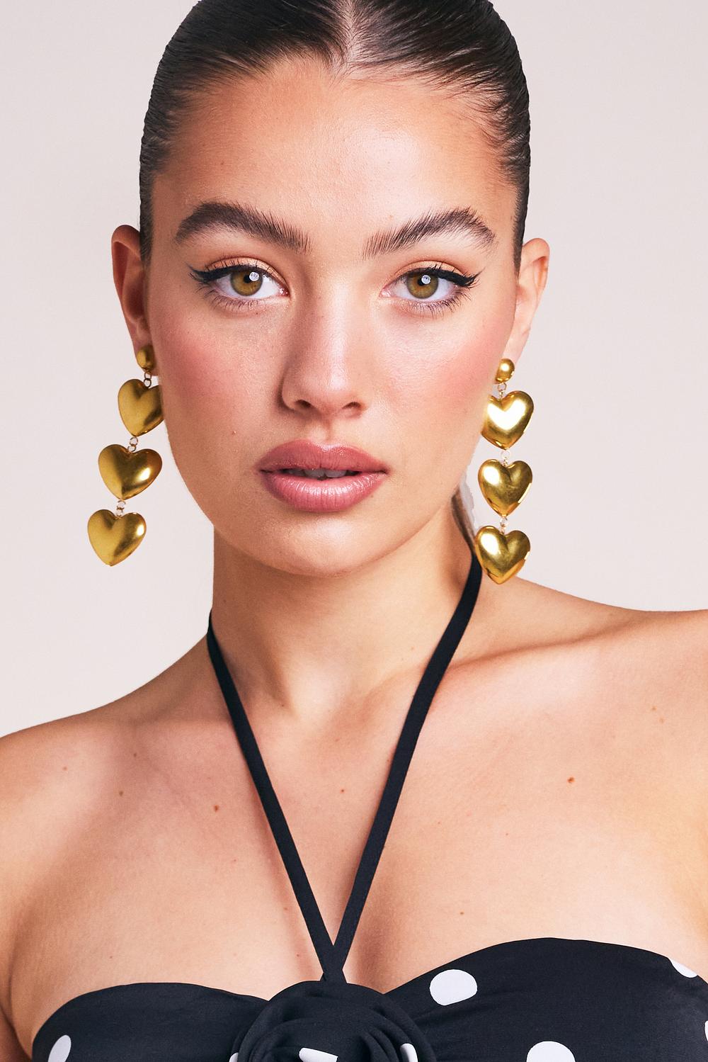 Golden earrings with heart shaped pendants