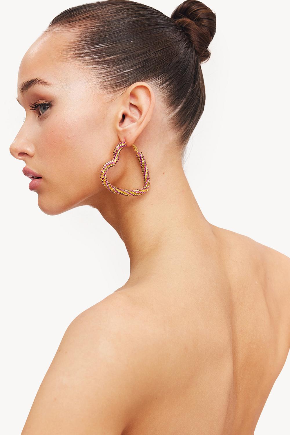 Golden earrings with pink rhinestones