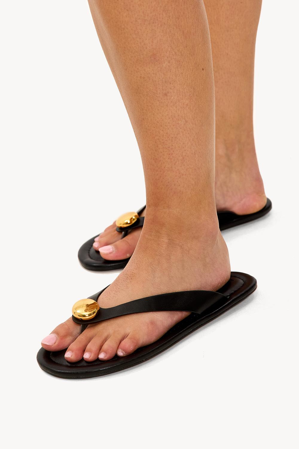 Black flip flops with gold detail