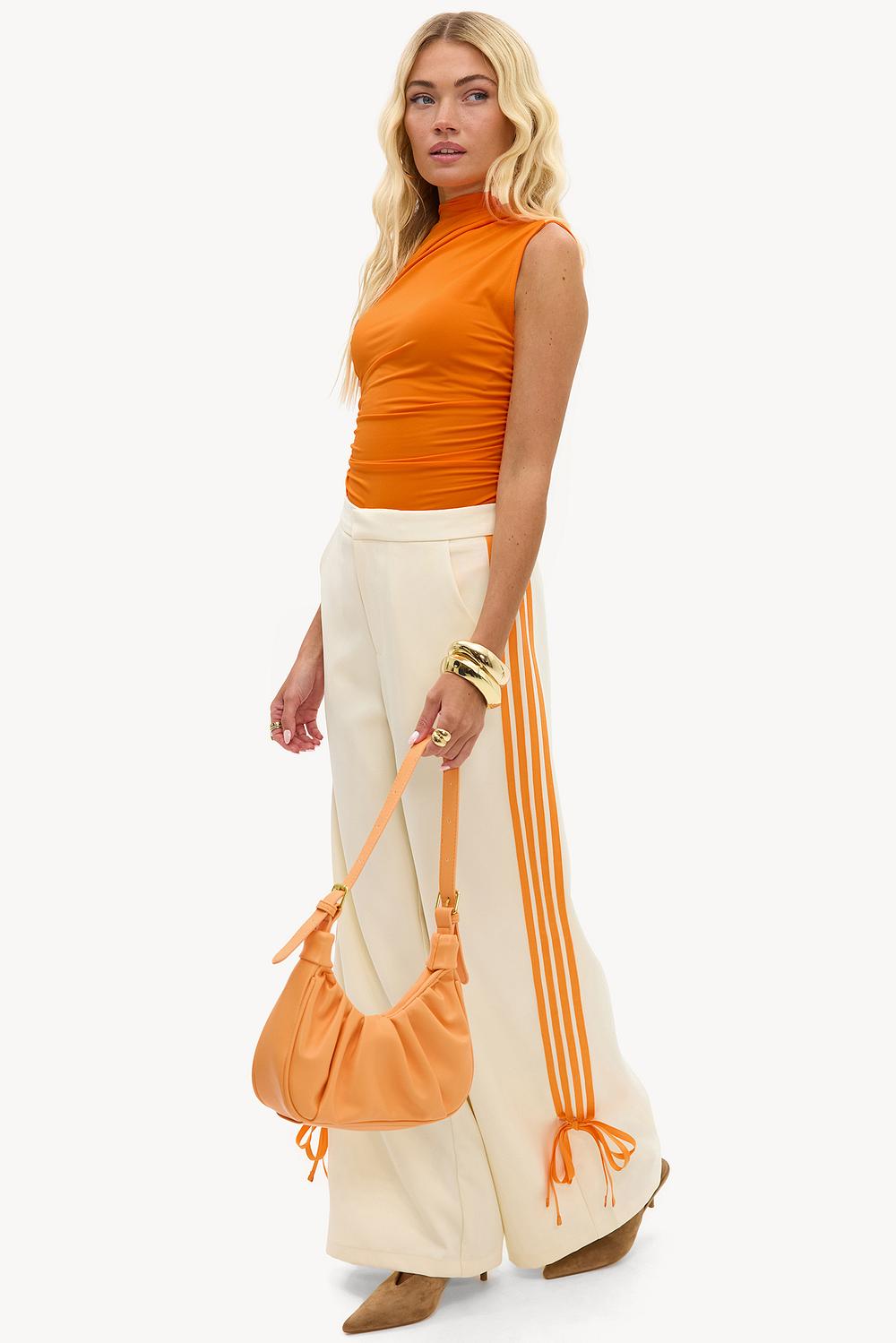 White track pants with orange stripe