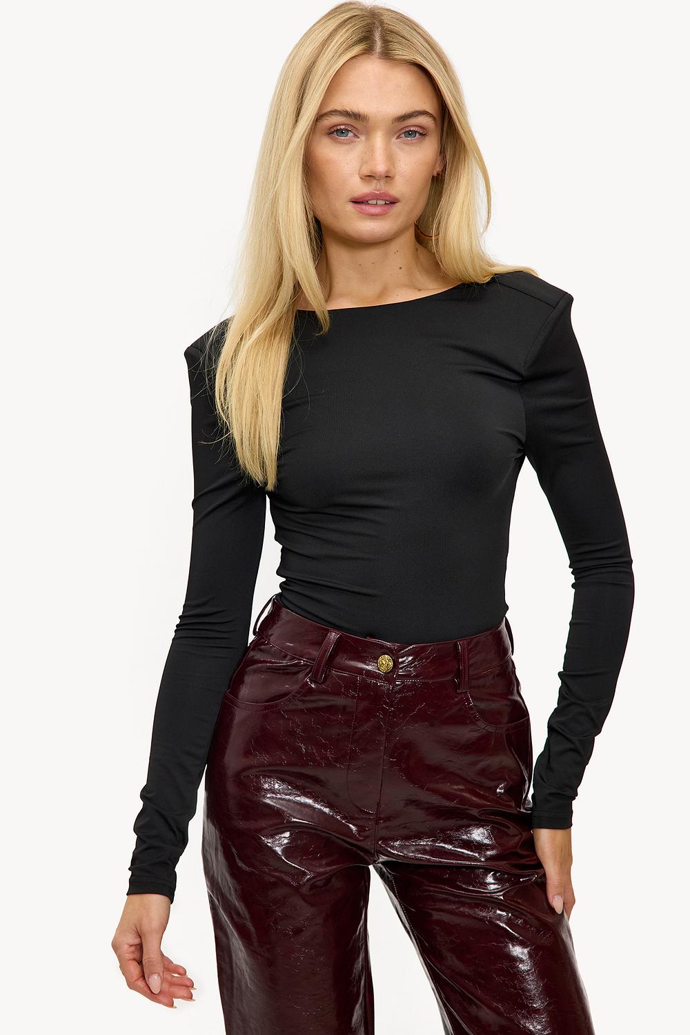 Black top with shoulder padding and draped back