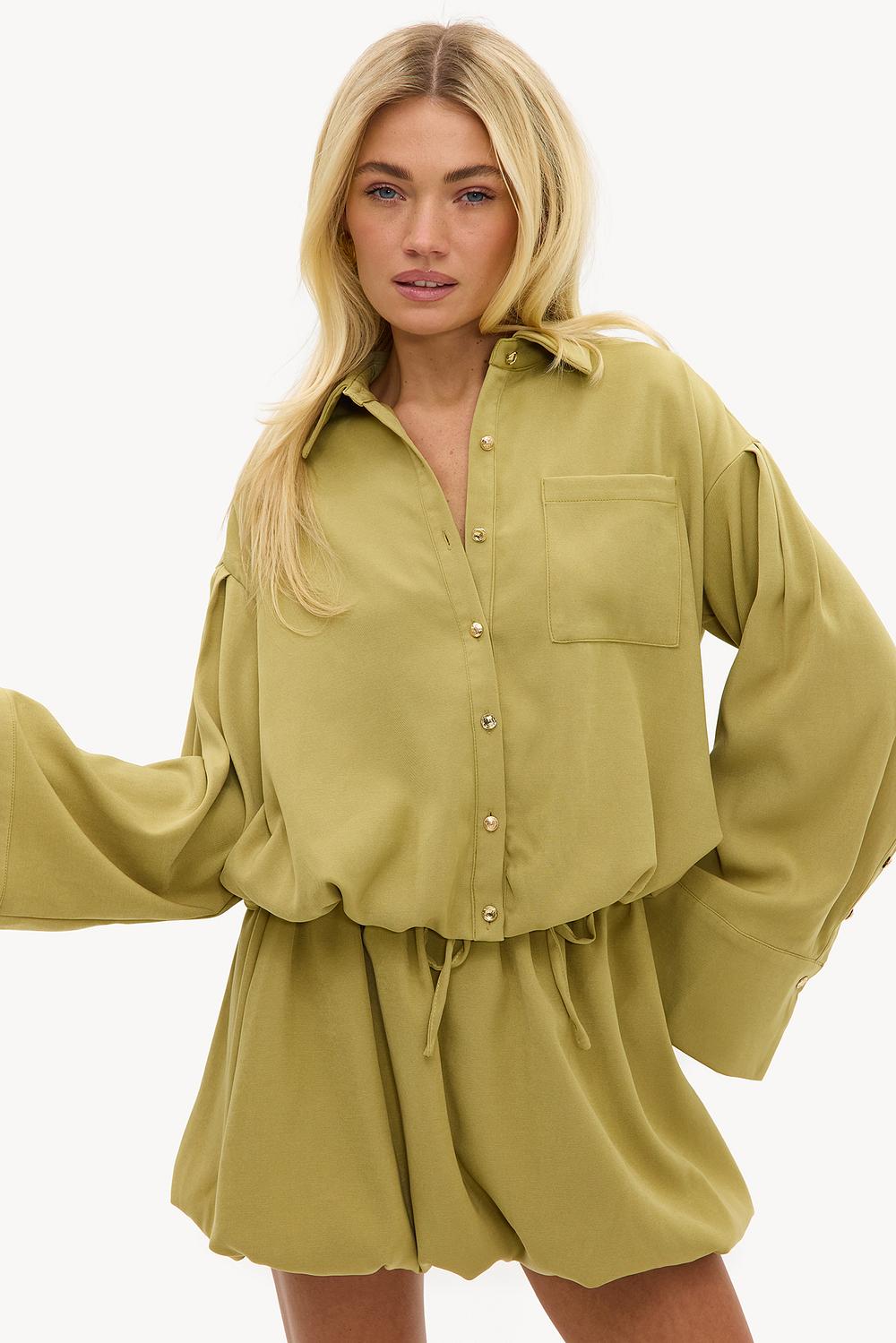 Light green balloon blouse with gold buttons and wide sleeves
