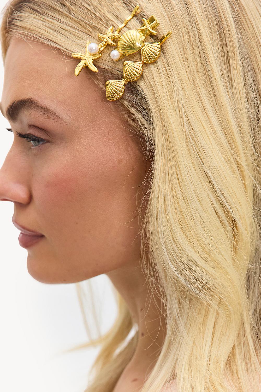 Barrettes dorées avec coquillages