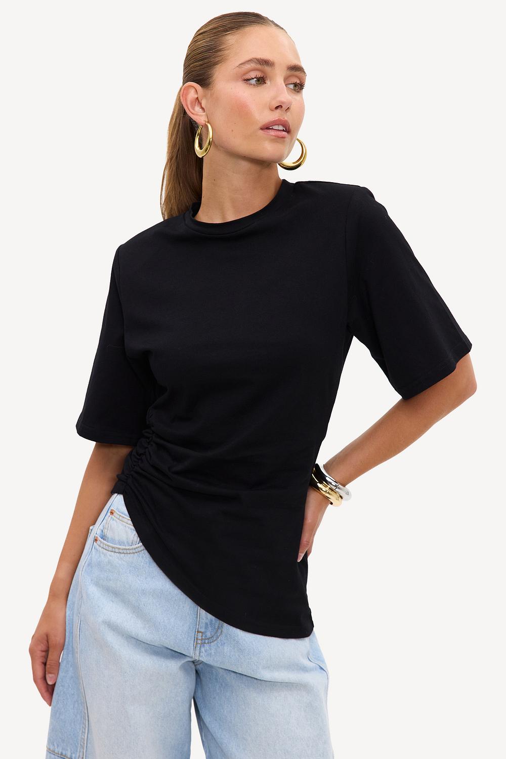 Black asymmetrical top with shoulder pads