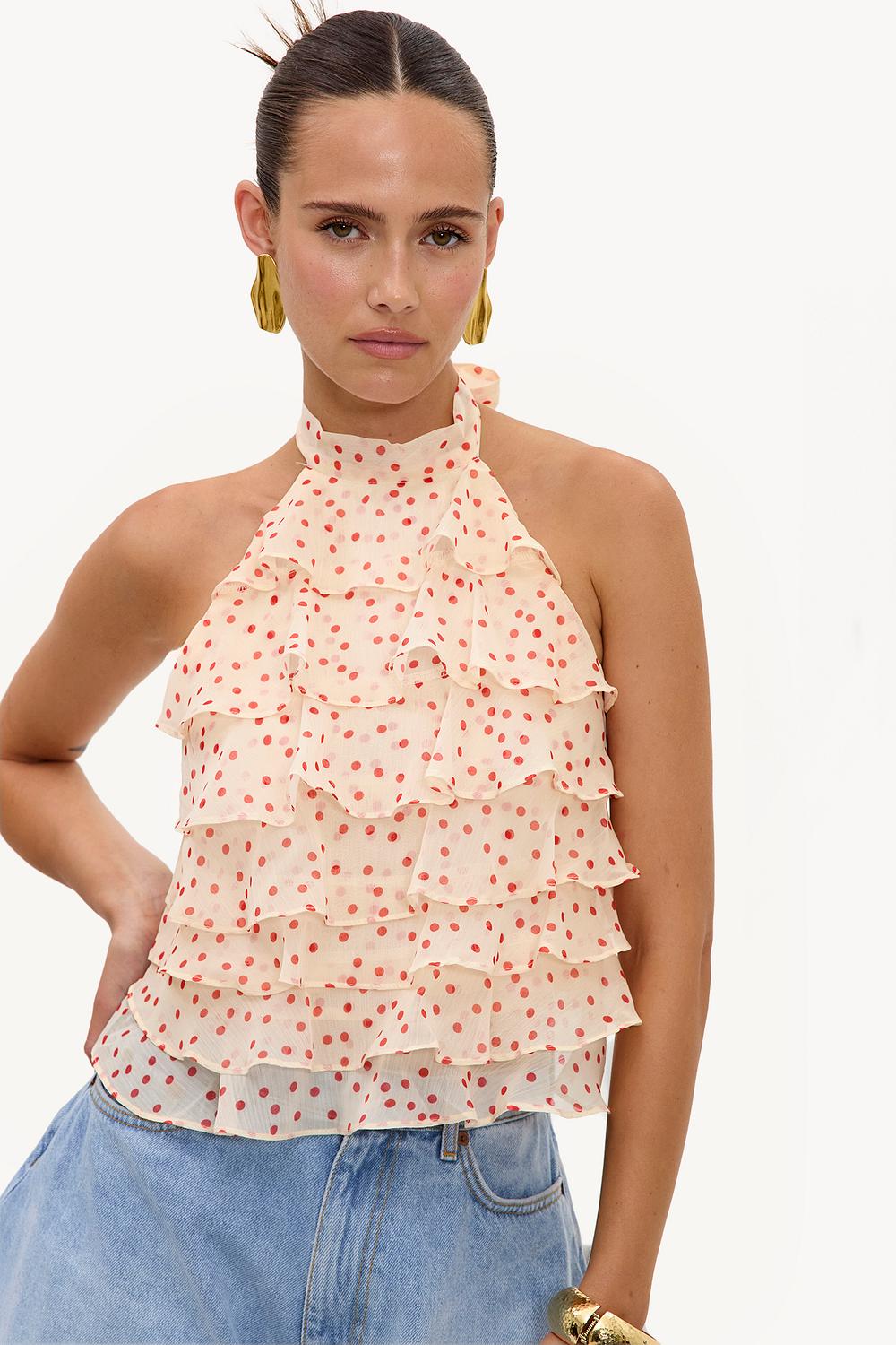 Cremekleurige haltertop met oranje polkadots en ruffles