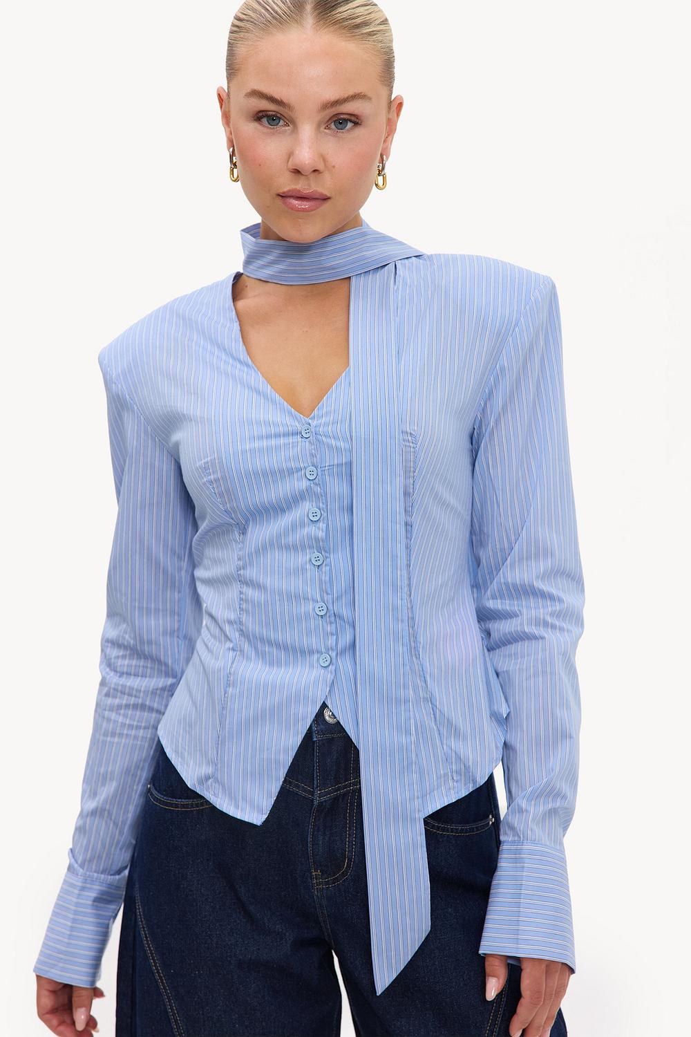 Light blue blazer with stripes, bow detail, and shoulder pads