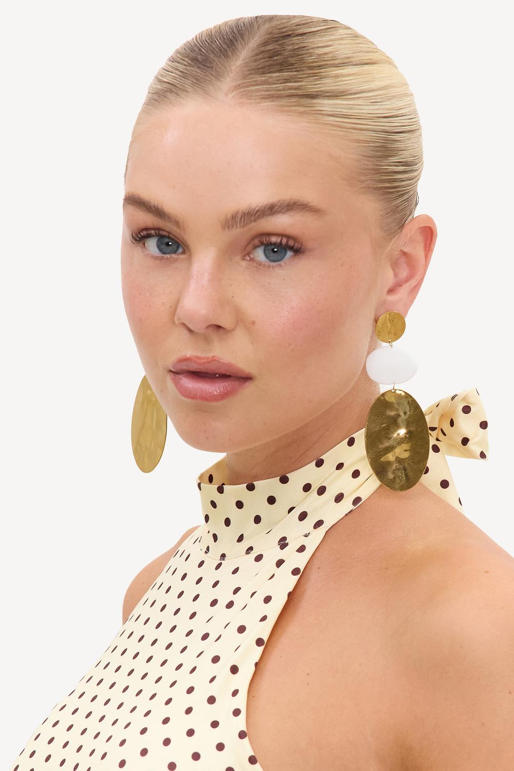 Gold statement earrings with white details