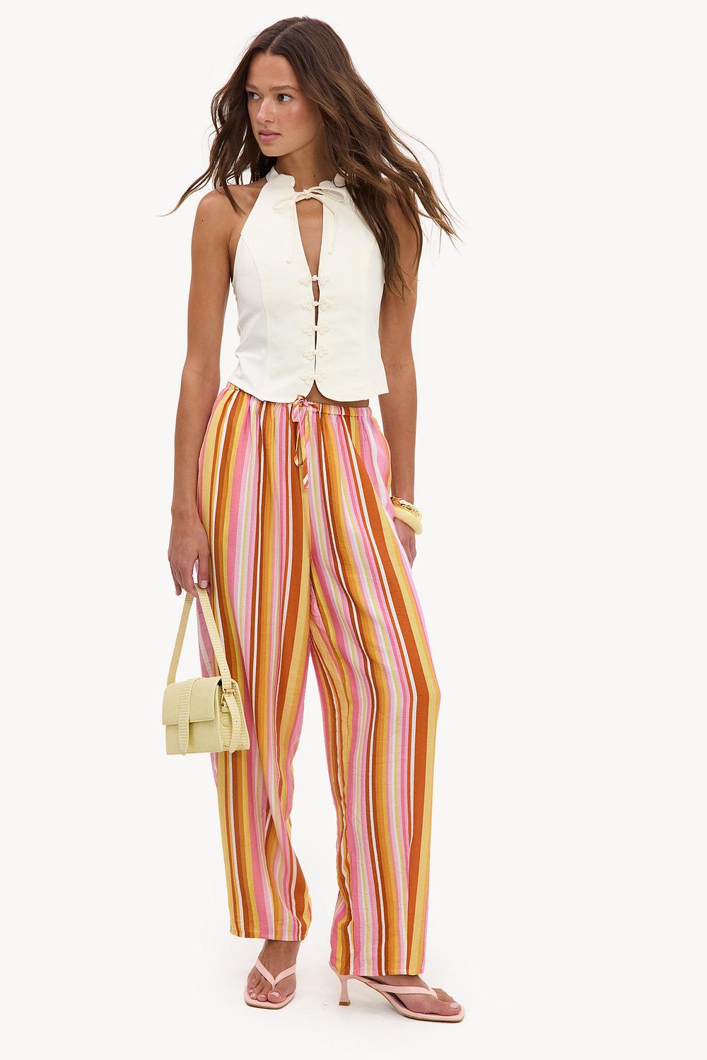 Pantalones anchos rosas con rayas amarillas y naranjas