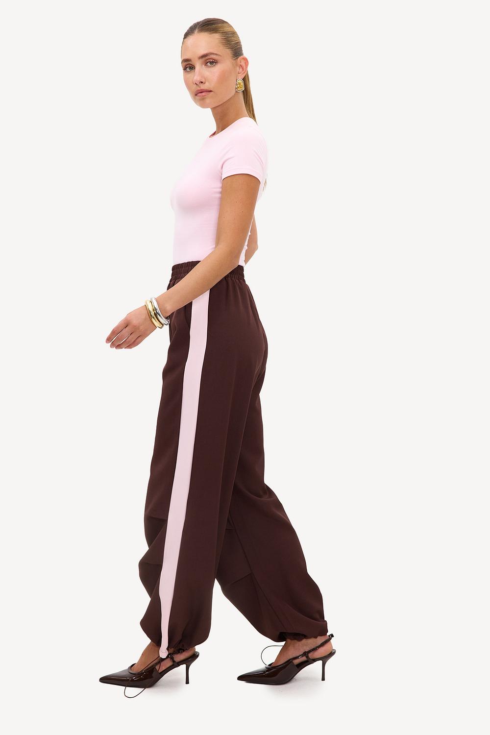 Brown tracksuit bottoms with light pink stripe