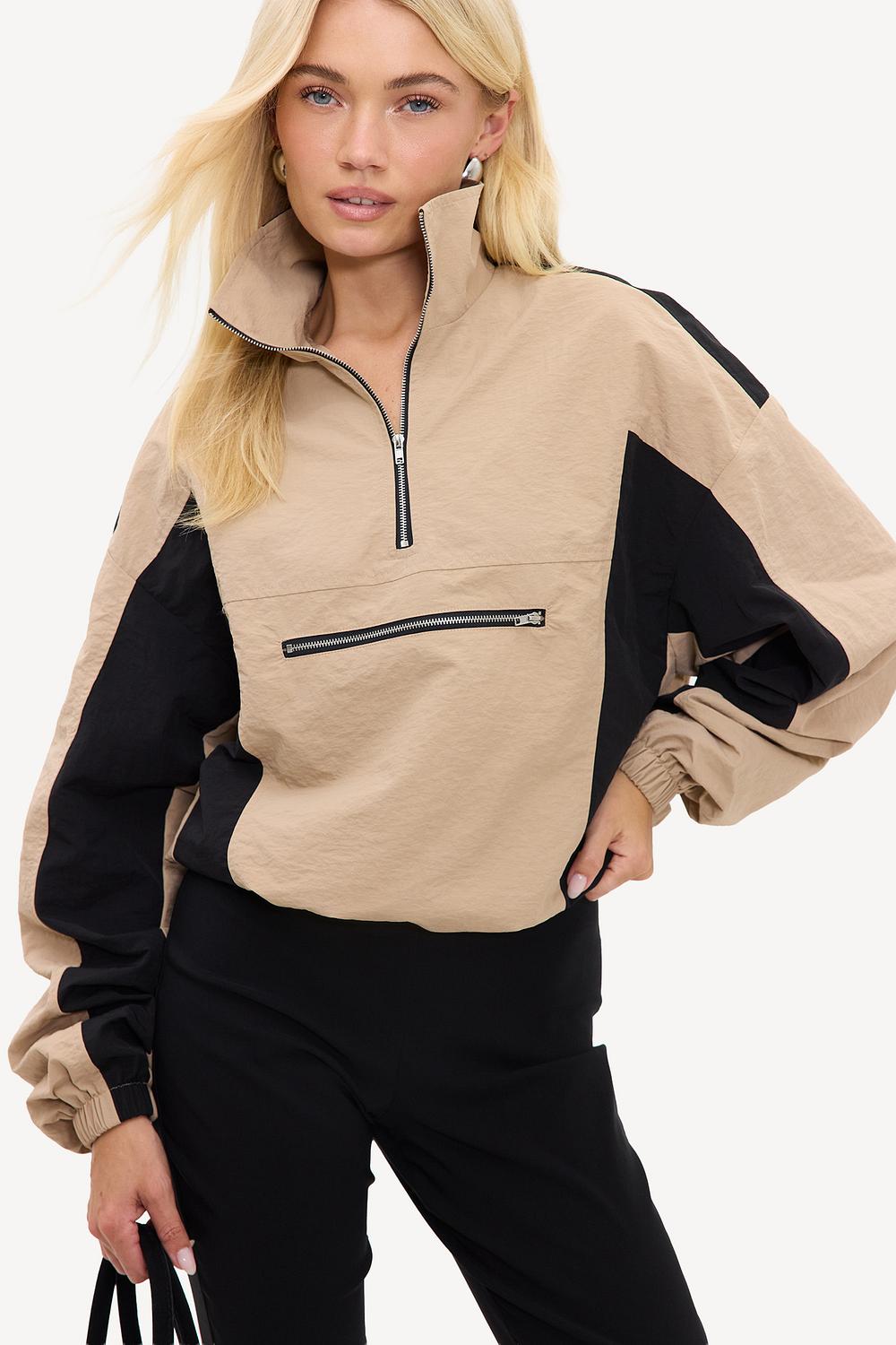Beige jacket with black details and zipper