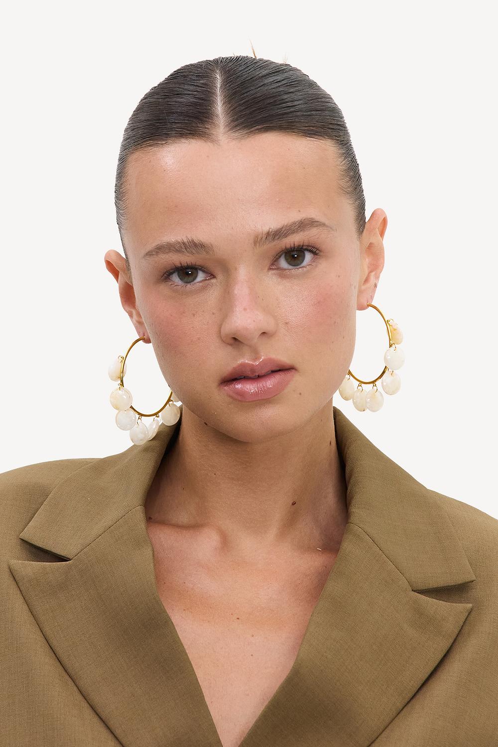 Gold hoop earrings with beige stones