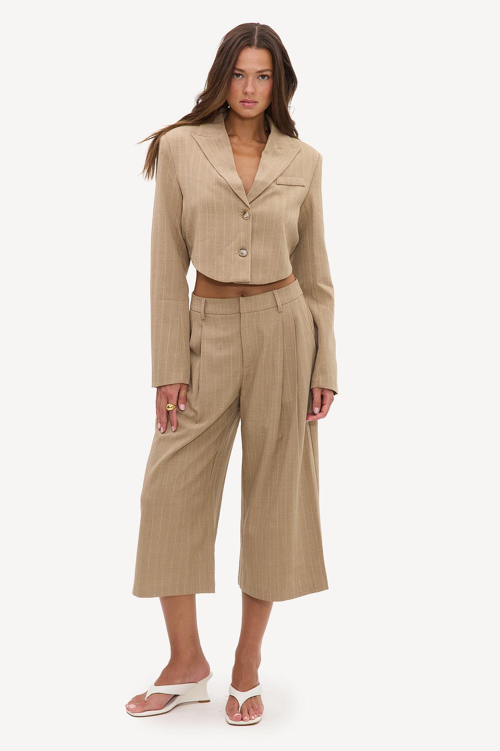 Camel-colored Bermuda shorts with white stripes