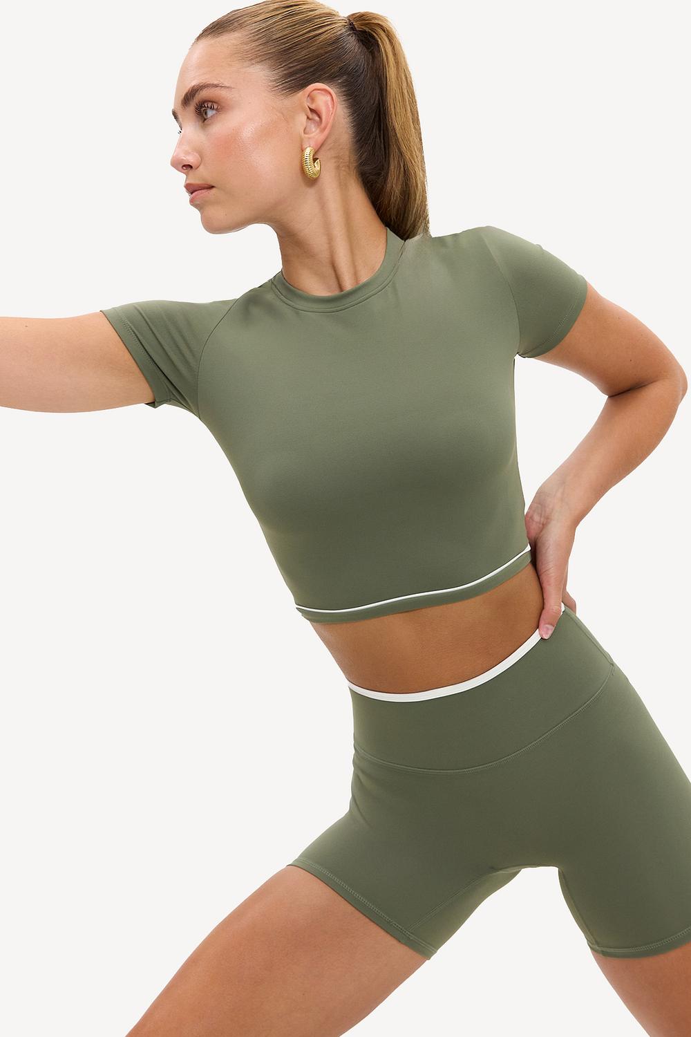 Light green cropped sports top with white details