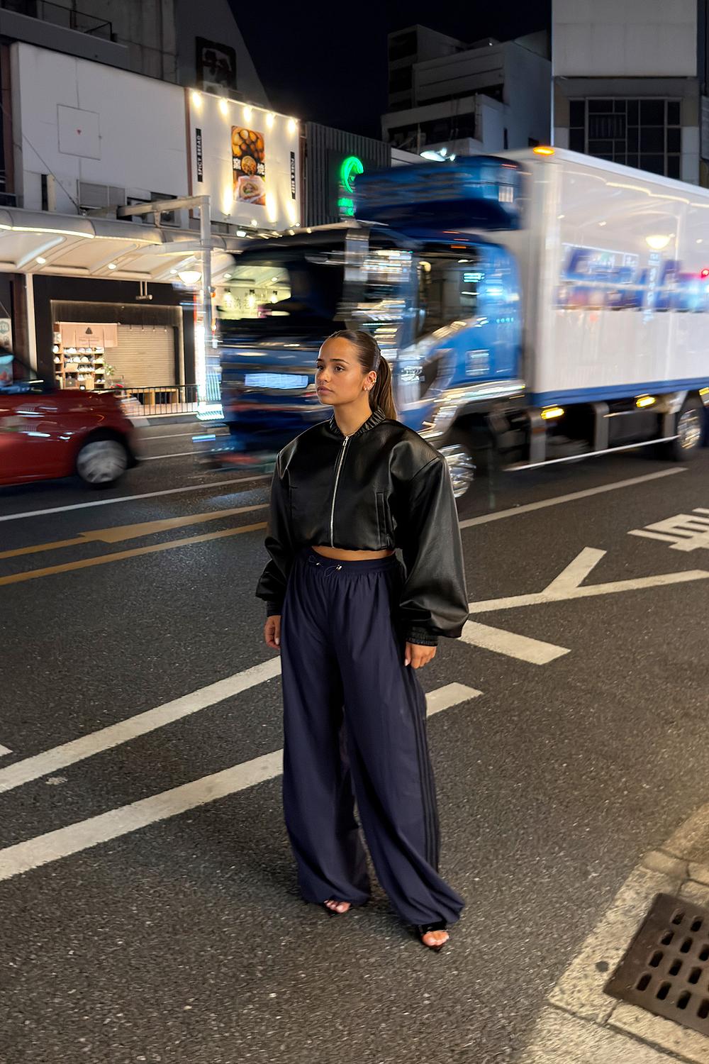 Dark blue parachute track pants with black stripe