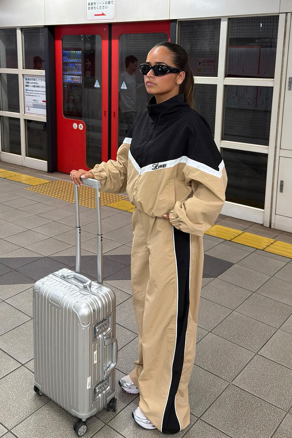 Beige tracksuit bottoms with black stripe